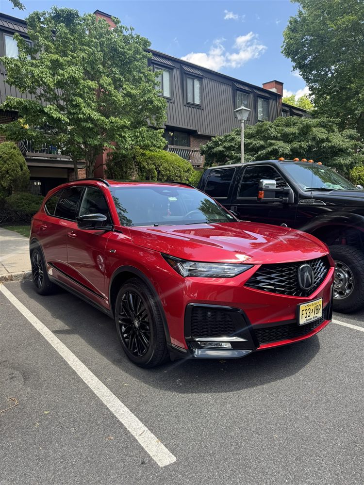 Freshly washed red Acura SUV